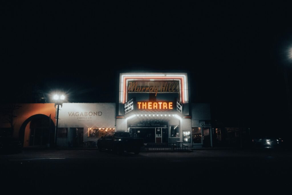Night view of Murray Hill Theatre in Jacksonville, FL, with neon lights glowing.