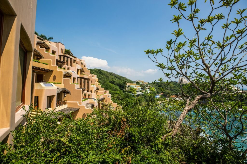 Stunning view of a tropical resort in Zihuatanejo, Mexico with lush greenery and ocean views.