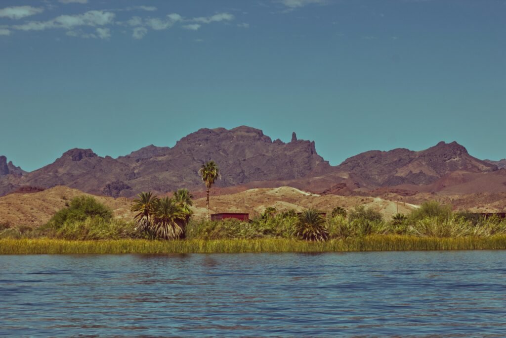 Beautiful landscape of Parker, AZ with mountains and river under a clear sky.